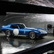 A photo showing sparks flying around a blue Renovo Coupe electric car.